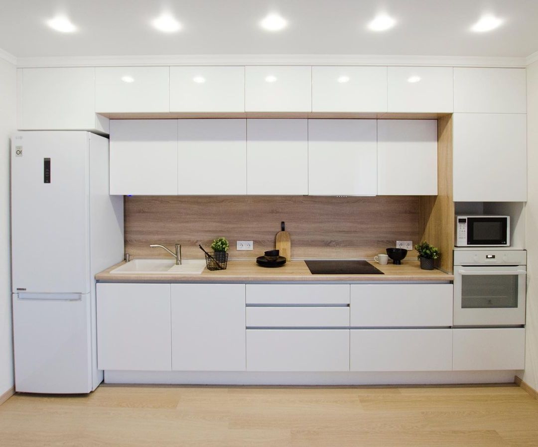 Фото прямая трехъярусная белая древесная двухцветная глянцевая светлая кухня с крашеными фасадами в стиле Хай-Тек и в стиле Минимализм с пластиковой столешницей