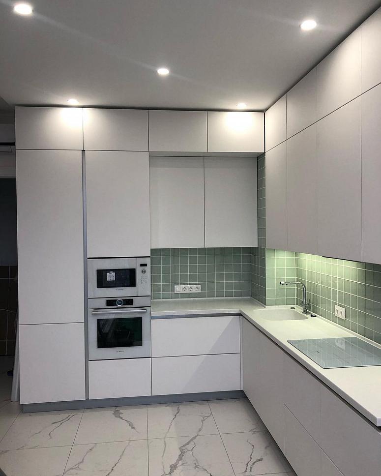 Фото угловая трехъярусная белая светлая матовая кухня с крашеными фасадами в стиле Хай-Тек и в стиле Минимализм с кварцевой столешницей