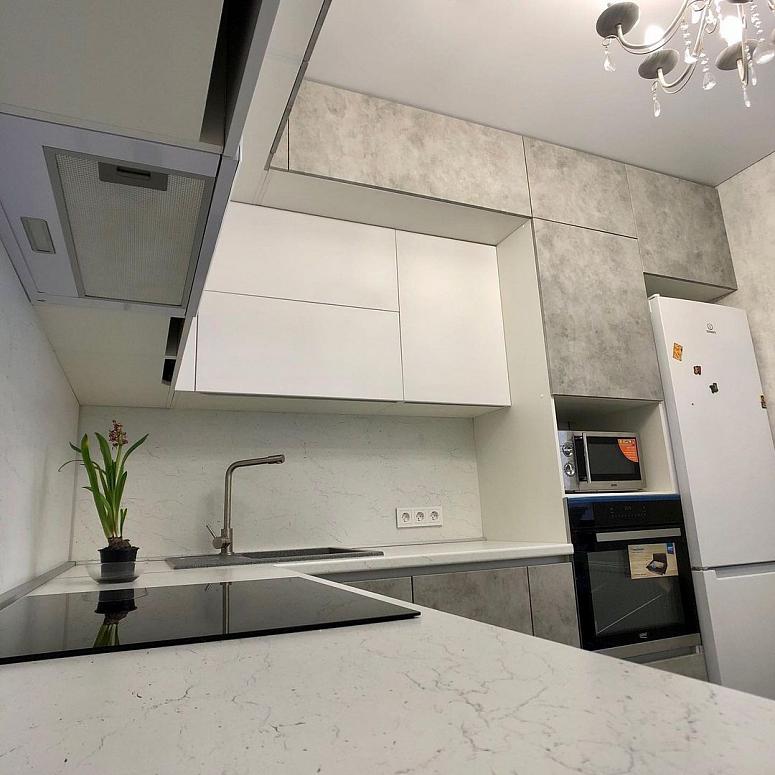 Фото угловая трехъярусная белая серая под камень кухня с фасадами МДФ-ПВХ в стиле Хай-Тек и в стиле Минимализм с пластиковой столешницей