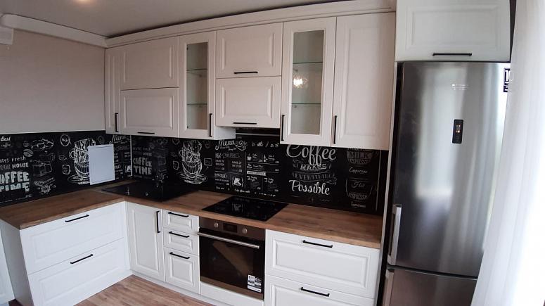 Фото угловая белая светлая матовая кухня с крашеными фасадами в классическом стиле с пластиковой столешницей